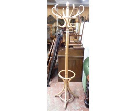A modern blonde bentwood freestanding hat and coat stand