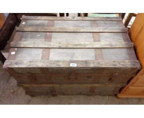An 88cm late Victorian wood and iron bound travelling trunk with canvas weather coating and tray fitted interior