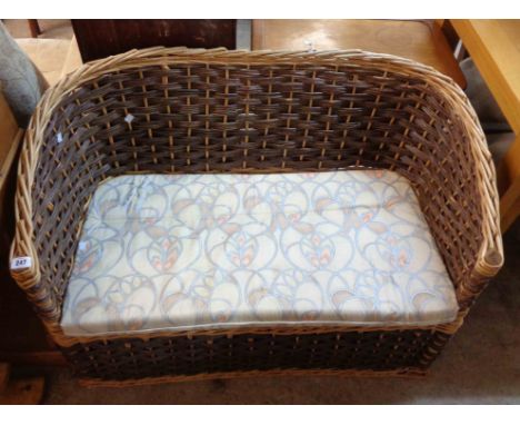 A 1.07m wicker bow shaped two seater settee with swab cushion