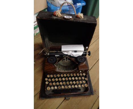 A vintage Royal portable typewriter with faux wood finish in original hard carry case (handle missing)