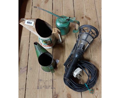 A vintage BP anti-freeze measure, a similar oil measure, an oil can, and a clip mounted work light