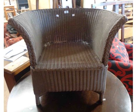 A vintage Lloyd Loom tub chair with later brown painted finish - no label