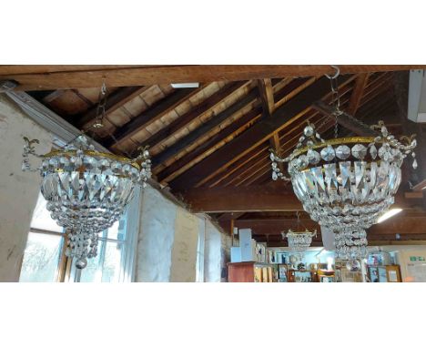 A set of three matching chandelier light shades of cascade lustre drop form with gilt metal fitting