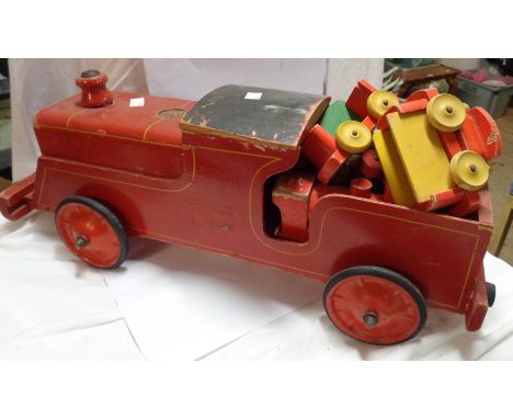 A large vintage wooden Tri-ang child's pull-along train toy with red painted finish - sold with a smaller Chad Valley similar