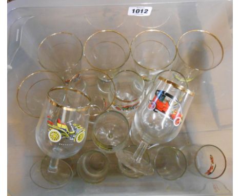 A crate containing a quantity of vintage glassware with printed veteran car decoration