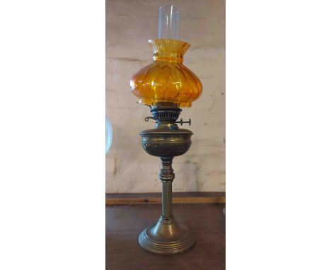 A brass oil lamp of column form, with chimney and painted amber shade - a/f