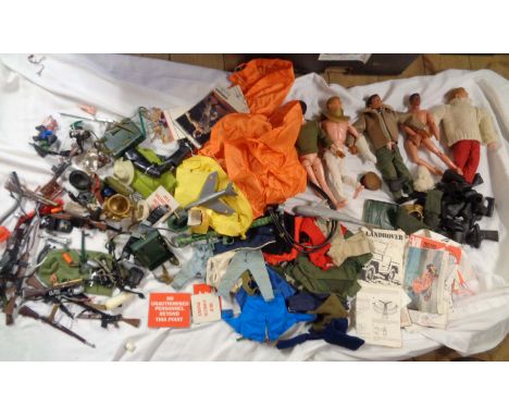 A large quantity of vintage Action Man figures and accessories including uniforms, signage, booklets, etc.