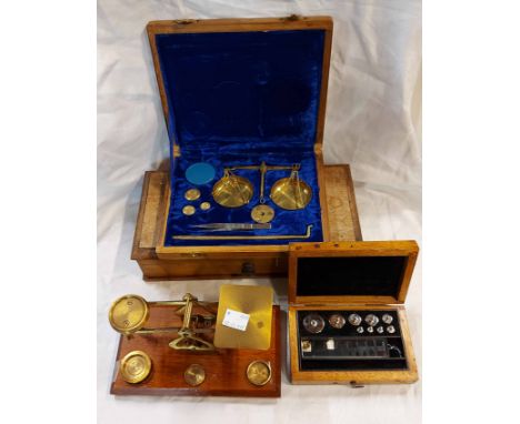 A set of old brass postal scales on wooden base - sold with two portable balance scales and a part set of weights
