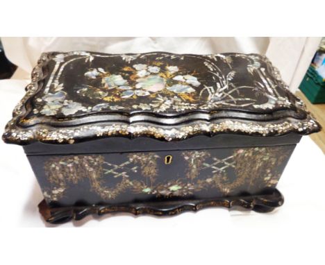 A Victorian papier mache tea caddy with painted and gilt decoration around mother-of-pearl inlay, the interior with two canis