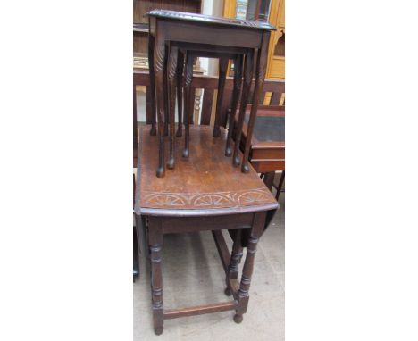 A 20th century oak gate leg dining table with a fan carved top on ring turned legs united by stretchers together with a nest 