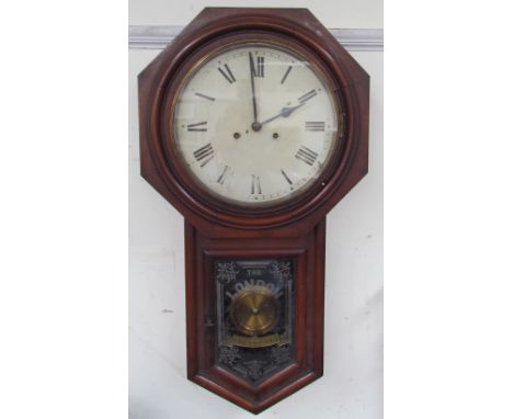 A British United Clock Co. “London Regulator” with a circular dial and Roman numerals, the base with a glazed door