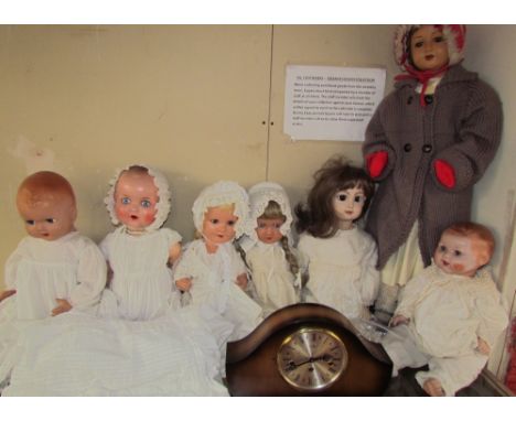 An Armand Marseille composition head doll together with a collection of dolls and a mantle clock