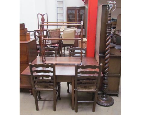 A 19th century oak gate leg dining table of rectangular form with drop flaps on square legs together with four ladder back ch