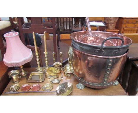 A copper and brass log basket, with lion head ring handles on paw feet together with a large copper twin handled pan, a coppe