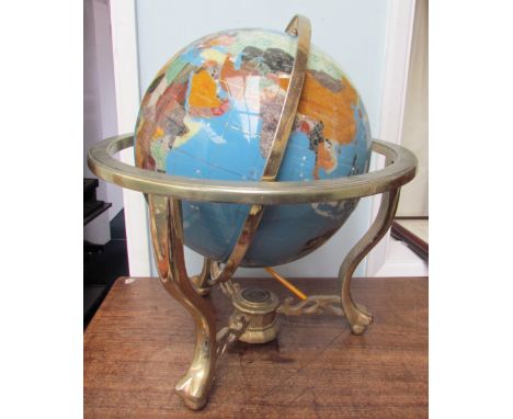 A gem set globe, with countries and continents depicted in abalone shell, and semi-precious stones to a gilt metal gimbal mou