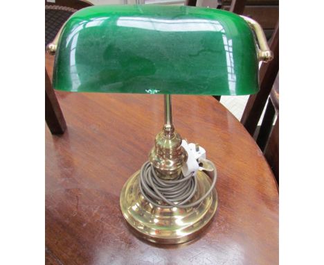 A green glass and brass desk light