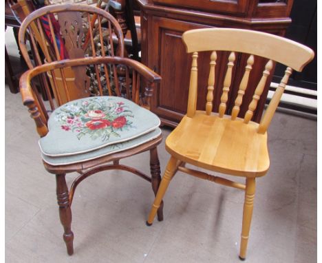 A yew Windsor chair with a hooped stick back with central vase splat above a solid seat on turned legs united by a crinoline 