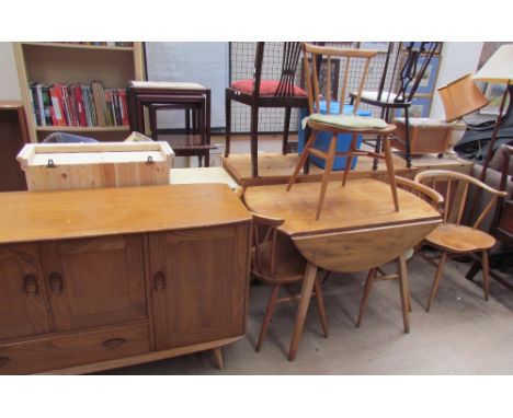 An Ercol light oak sideboard, together with a table and four chairs CONDITION REPORT: in used condition, watermarks and surfa