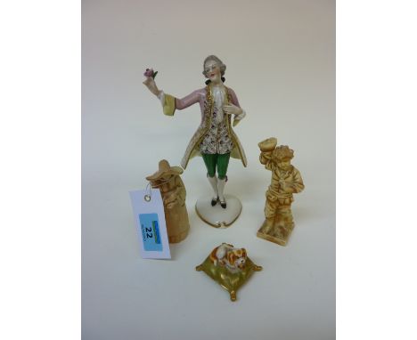 Royal Worcester candle snuffer in the form of a nun, a Royal Worcester figure of King Charles Spaniel on a cushion and one ot