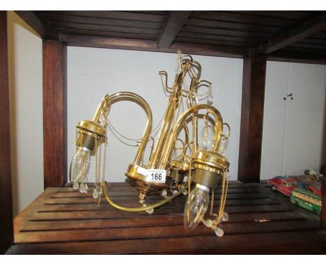 A brass 3 lamp ceiling light.