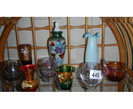 A shelf of coloured glass,