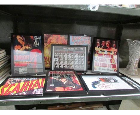 A shelf of framed and glazed entertainment advertisements.