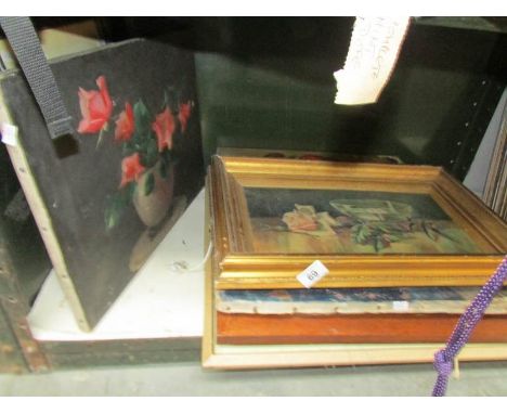 A shelf of paintings and prints.