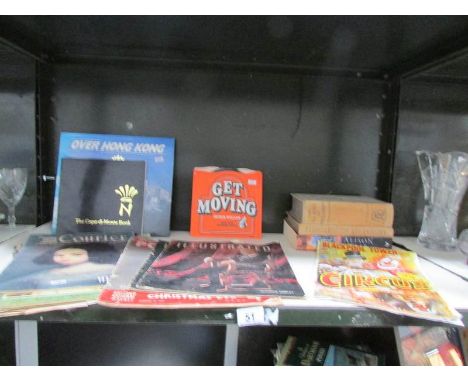 A shelf of books, magazines, programmes etc.,