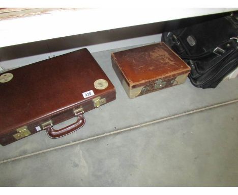 A small vintage suitcase, a briefcase and one other case.