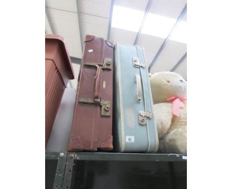A vintage leather suitcase and one other,