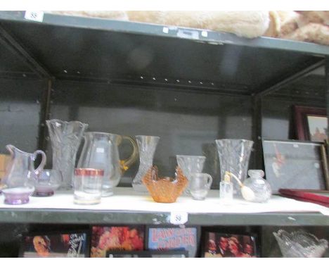 A shelf of assorted glass ware.
