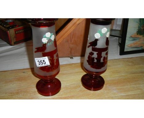 A pair of ruby glass engraved vases.