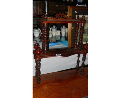 A small mahogany wall shelf.