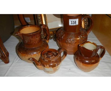 3 Doulton stone ware jugs and a teapot, some a/f.