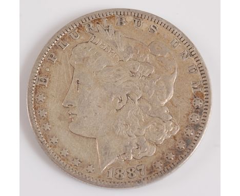 U.S.A., 1887 silver Morgan dollar, obv; Liberty head above date, rev; spread-eagle with crossed arrows within wreath, New Orl