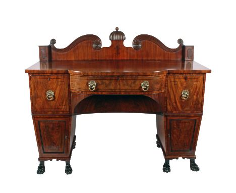 A Regency mahogany bow front pedestal sideboard, c.1810, the shaped and reeded swan-necked back with raised finial centre, th