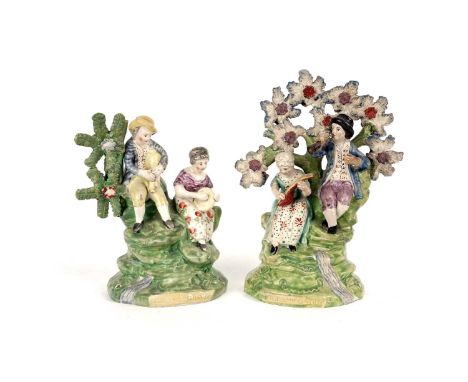 An early 19th Century pearlware figure impressed 'Village Group', depicting a boy with pipes and a girl with tambourine, 17cm