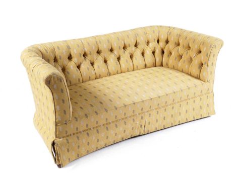 A neat early 20th Century Edwardian two seat sofa, with roll over top edge, buttoned back rest and sprung seat, upholstered i