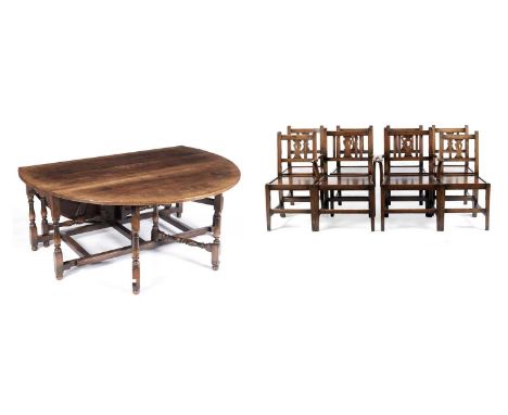 A Titchmarsh and Goodwin large oak drop leaf table with eight dining chairs, the table with D-shaped leaves opening onto gate