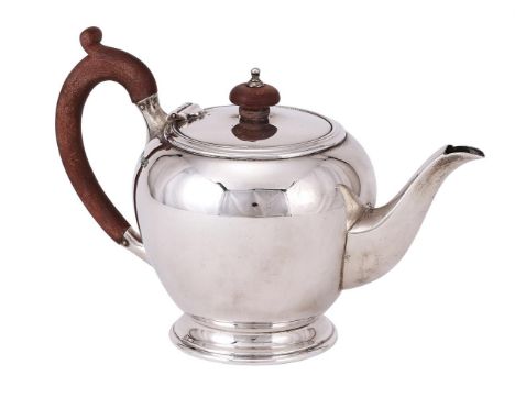 
	
		A SILVER BULLET SHAPED TEA POT
		MAPPIN &amp; WEBB, SHEFFIELD 1957
		With wood domed finial and loop handle, on a circul