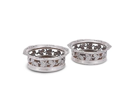 
	
		A PAIR OF GEORGE III SILVER MOUNTED SHAPED CIRCULAR COASTERS
		S. C. YOUNGE &amp; CO., SHEFFIELD 1813
		With shaped circ