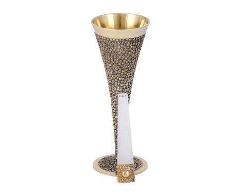 
	
		A SILVER GILT FLUTED VASE
		STUART DEVLIN, LONDON 1968
		With a textured body and on a circular foot
		18cm (7in) high
	