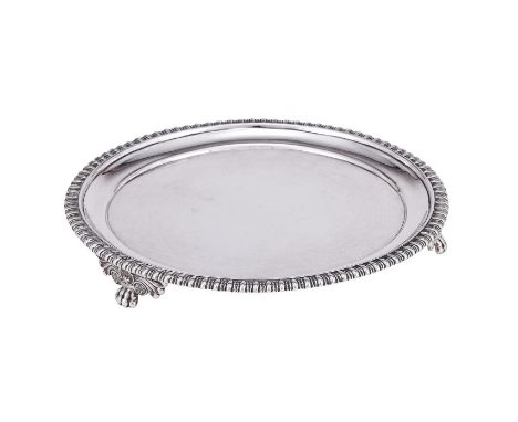 
	
		A GEORGE IV SILVER CIRCULAR WAITER
		MAKER&#39;S MARK WE, LONDON 1826
		With a gadrooned border and on three scroll and 