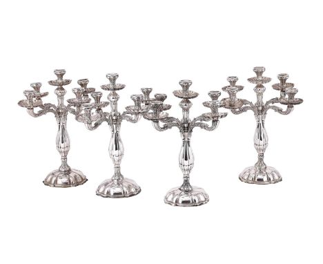 
	
		A SET OF FOUR SPANISH SILVER FIVE LIGHT CANDELABRA
		POST 1934 MARK
		With foliate waisted capitals, shaped circular dri