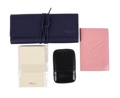 
	
		CHOPARD, A LEATHER JEWELLERY ROLL, NOTEPAD HOLDER AND CARD CASE 
		The dark blue jewellery roll with purple fabric inter