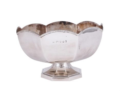 
	
		A SILVER SHAPED CIRCULAR ROSE BOWL
		S. J. ROSE &amp; SON, LONDON 1977
		With a Celtic band border and on an octagonal p