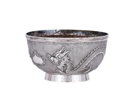 
	
		A CHINESE SILVER BOWL
		GUANG LI, SHANGHAI, CIRCA 1900
		Embossed with dragons and on a circular foot
		12cm (4 3/4in) d