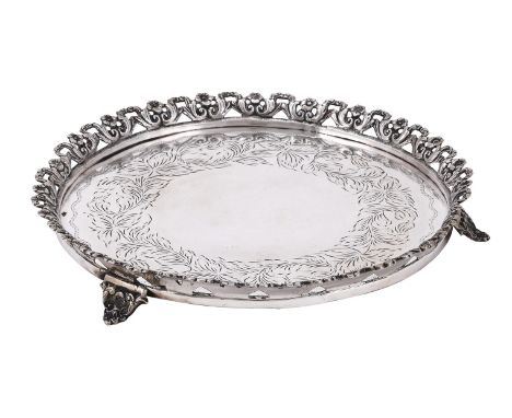 
	
		A CONTINENTAL SILVER COLOURED SHAPED CIRCULAR SALVER
		STAMPED 830
		With a cast floral border, engraved with a foliate 