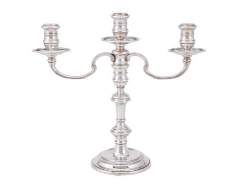 A SILVER THREE LIGHT CANDELABRA WILLIAM COMYNS &amp; SONS LTD., THE CANDLESTICK LONDON 1961 AND THE ARMS 1964 With reel capit