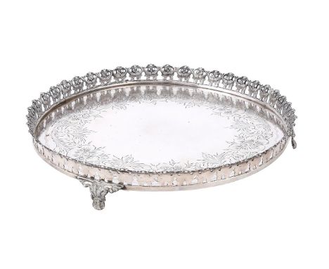 
	
		A CONTINENTAL SILVER COLOURED SHAPED CIRCULAR SALVER
		STAMPED PRATA 835
		With a foliate scroll border, engraved with a